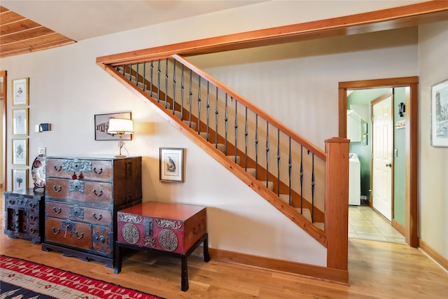42746 Knuppel Ln, Big Arm, MT 59910 - stairway featuring wood finished floors, baseboards, washer / clothes dryer, and wood ceiling