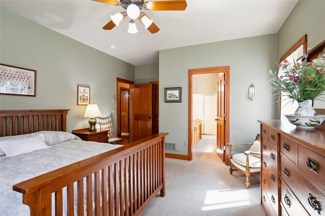 42746 Knuppel Ln, Big Arm, MT 59910 - bedroom featuring light carpet, baseboards, ceiling fan, and ensuite bathroom