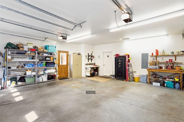 42746 Knuppel Ln, Big Arm, MT 59910 - garage with a garage door opener, electric panel, and a workshop area