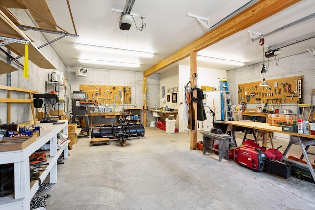 42746 Knuppel Ln, Big Arm, MT 59910 - garage featuring a workshop area and a garage door opener