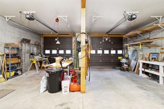 42746 Knuppel Ln, Big Arm, MT 59910 - garage featuring a garage door opener and a workshop area