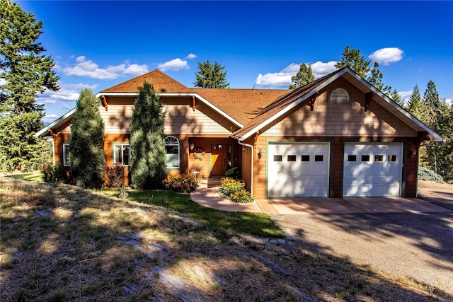 42746 Knuppel Ln, Big Arm, MT 59910 - view of front of home featuring driveway, an attached garage, and a shingled roof
