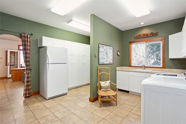 42746 Knuppel Ln, Big Arm, MT 59910 - washroom with light tile patterned floors, arched walkways, independent washer and dryer, and baseboards