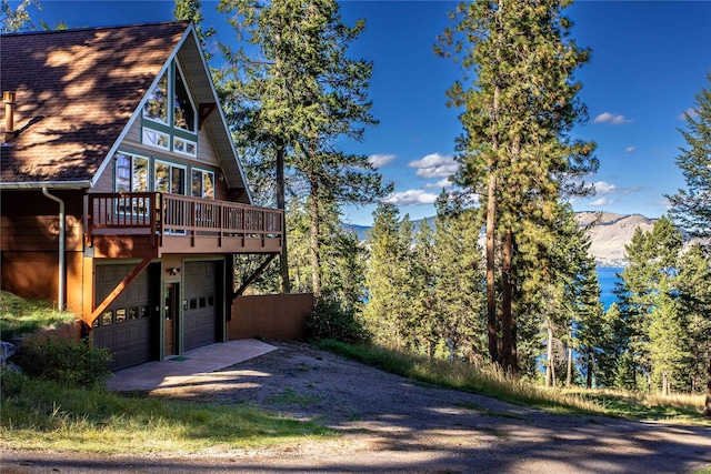 42746 Knuppel Ln, Big Arm, MT 59910 - view of property exterior with driveway, a garage, and a mountain view