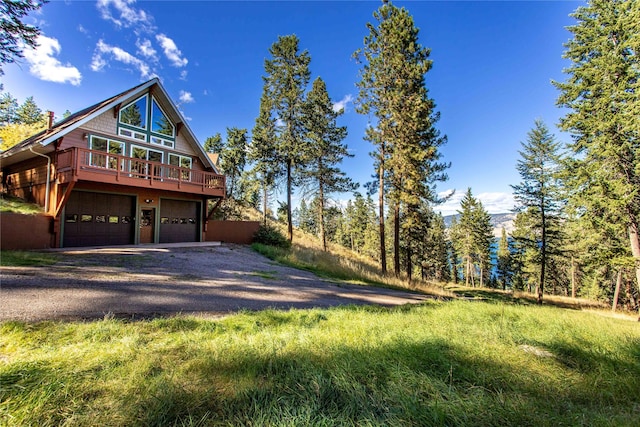 42746 Knuppel Ln, Big Arm, MT 59910 - view of property exterior featuring dirt driveway and an attached garage
