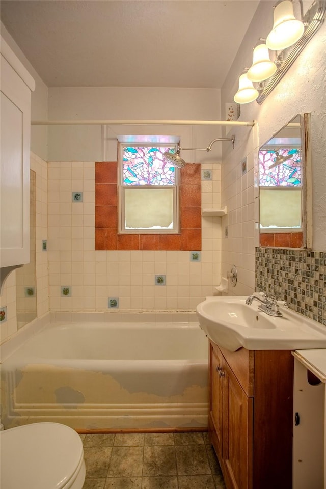 422 11th Ave, Helena, MT 59601 - bathroom featuring vanity, toilet, shower / bath combination, and backsplash