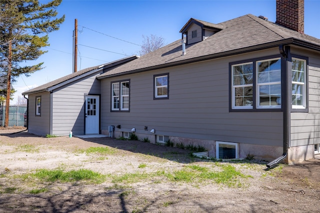 10 S Meridian Rd, Kalispell, MT 59901 - rear view of property featuring roof with shingles and a chimney