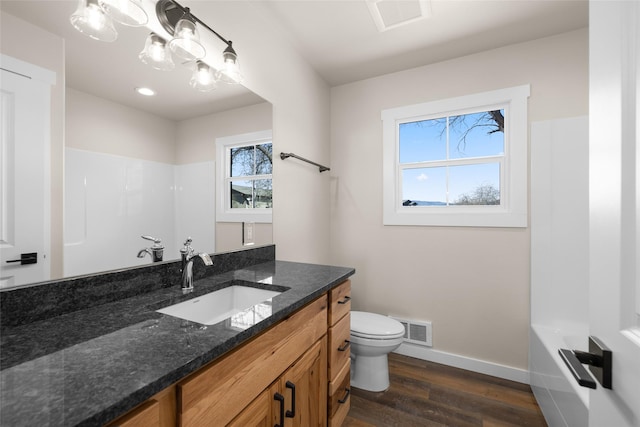 full bath with baseboards, toilet, visible vents, and wood finished floors