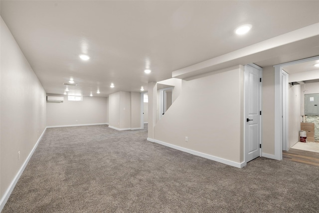 basement with a wall mounted AC, carpet floors, and recessed lighting