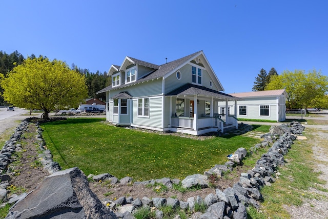 view of home's exterior with a yard and a porch