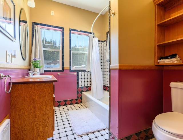 full bath with tile patterned floors, toilet, vanity, and shower / bathtub combination with curtain