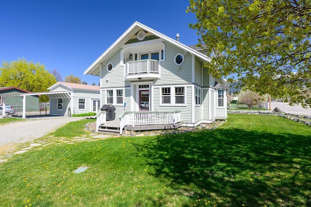 view of front of home with a front lawn, driveway, a wooden deck, and a balcony