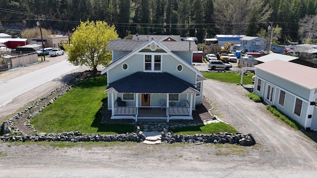 birds eye view of property featuring a view of trees
