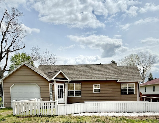 view of front facade featuring fence private yard and a shingled roof