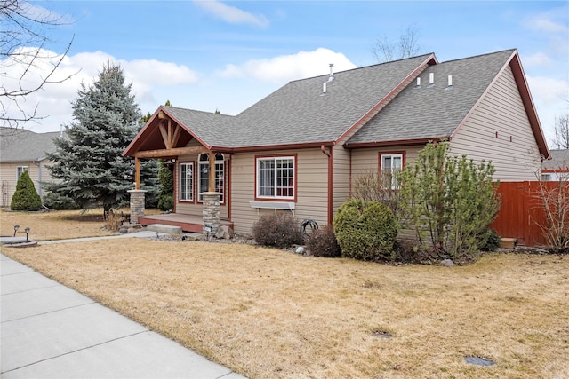3817 Concord Dr, Missoula, MT 59808 - view of front of home with a porch, roof with shingles, fence, and a front yard