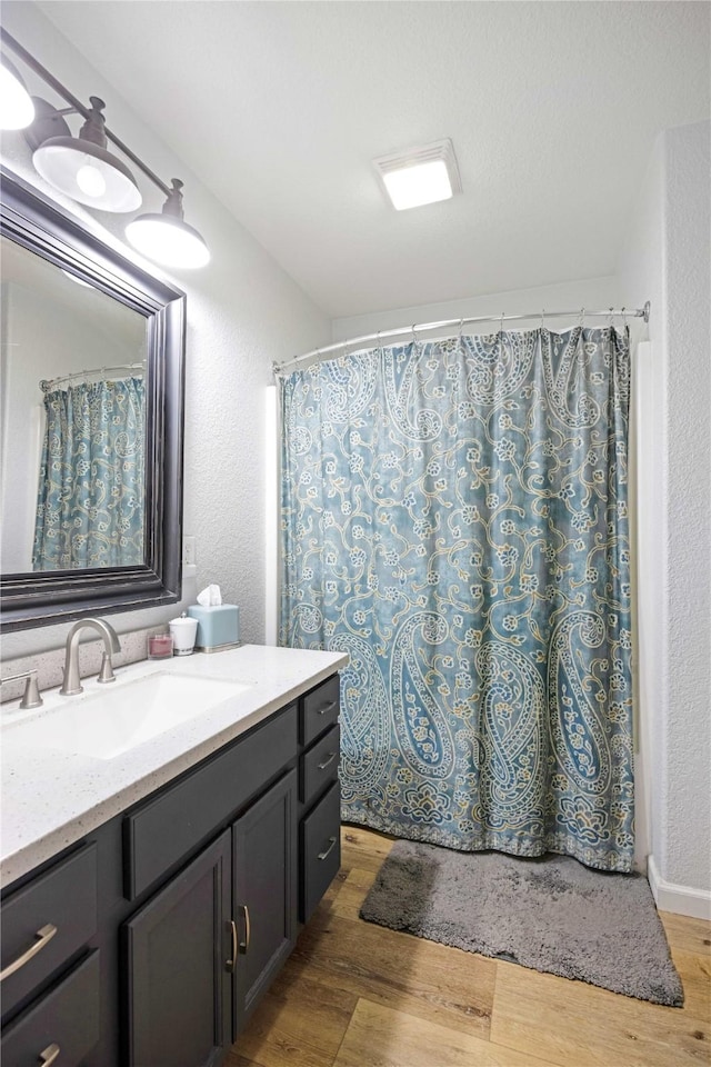 3817 Concord Dr, Missoula, MT 59808 - full bath with a shower with curtain, vanity, and wood finished floors