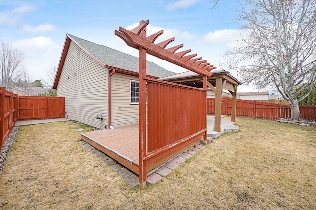 3817 Concord Dr, Missoula, MT 59808 - view of side of home featuring a lawn, a deck, a shingled roof, and a fenced backyard