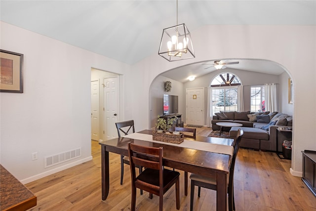 3817 Concord Dr, Missoula, MT 59808 - dining area with arched walkways, lofted ceiling, light wood-type flooring, and visible vents