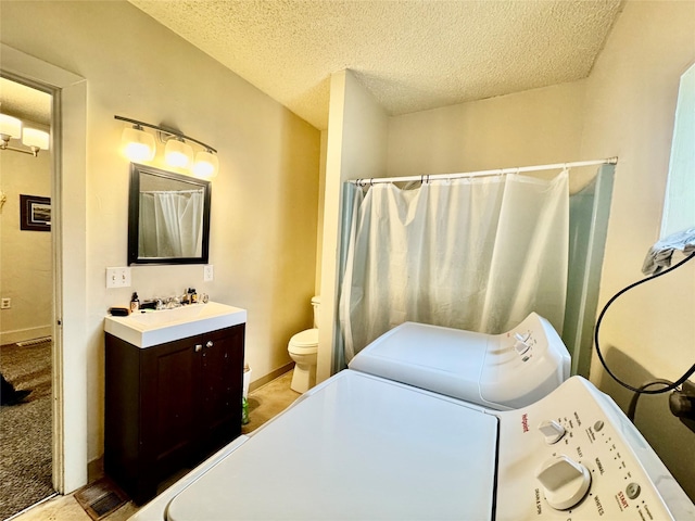 208 2nd Ave S, Belt, MT 59412 - washroom featuring a sink, laundry area, washing machine and clothes dryer, a textured ceiling, and baseboards