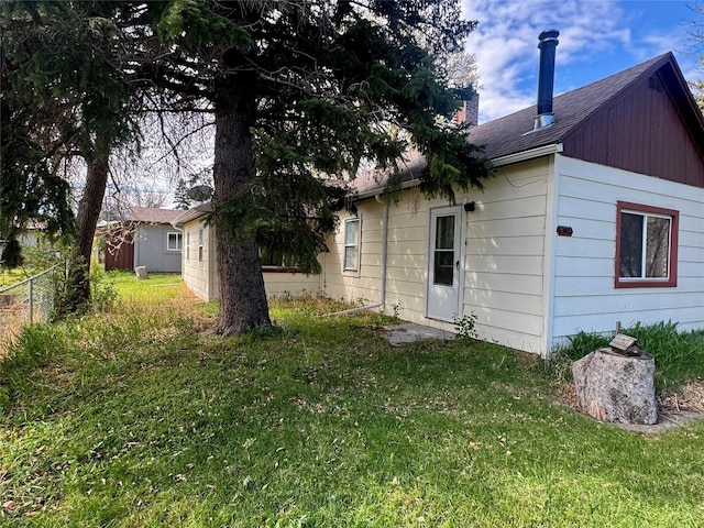 208 2nd Ave S, Belt, MT 59412 - rear view of house featuring roof with shingles, fence, and a lawn