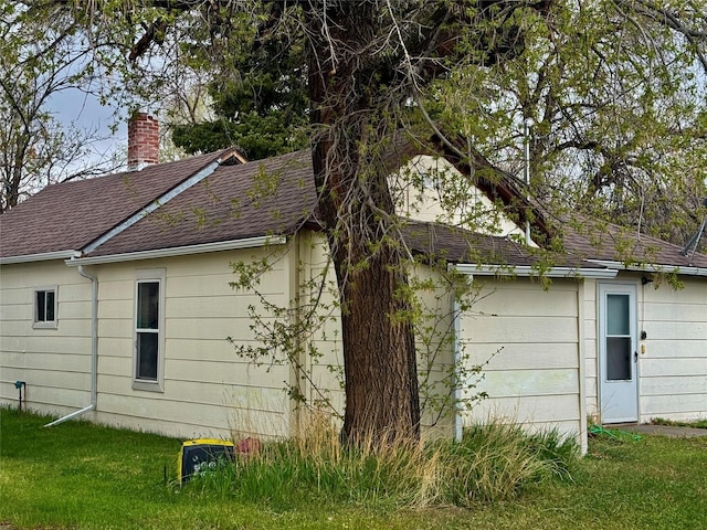 208 2nd Ave S, Belt, MT 59412 - view of property exterior featuring a chimney, a yard, and a shingled roof