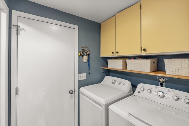 washroom with washer and dryer and cabinet space