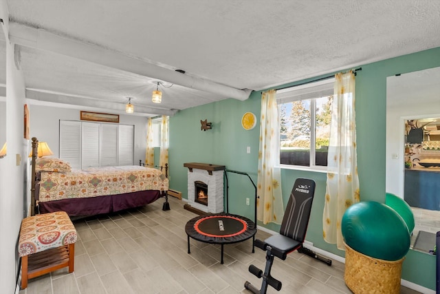 bedroom with multiple windows, a closet, and baseboards