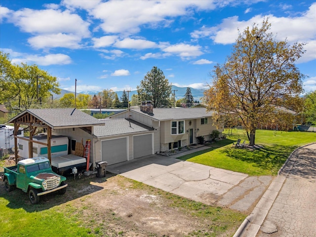 view of front of home featuring a garage, a chimney, a shingled roof, a front yard, and driveway