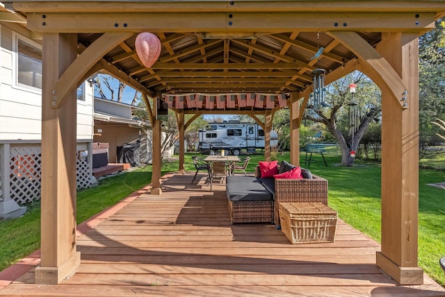 wooden deck with a gazebo, outdoor dining space, and a lawn