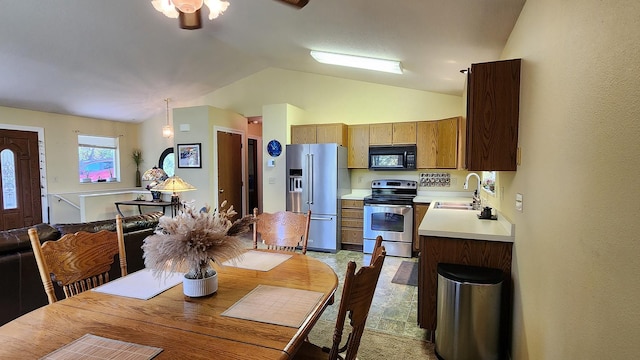 dining area with a ceiling fan and lofted ceiling