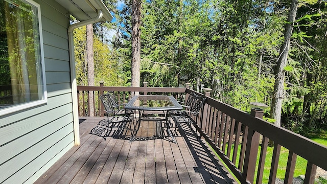 wooden terrace featuring outdoor dining area