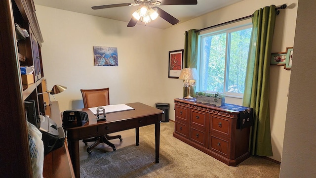 office with light colored carpet and a ceiling fan