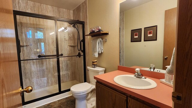 full bathroom featuring vanity, toilet, and a stall shower
