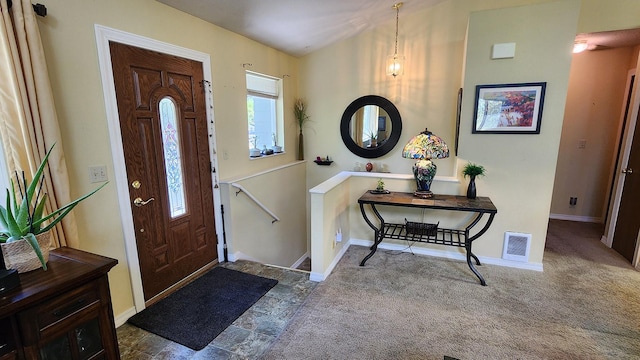 foyer entrance featuring baseboards and visible vents