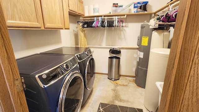 laundry area with washing machine and clothes dryer and cabinet space