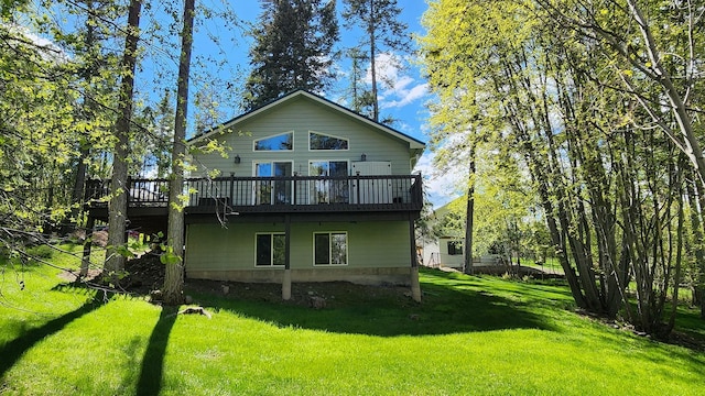 back of house featuring a wooden deck and a lawn