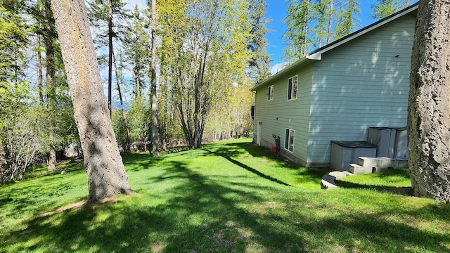 view of side of home with a lawn