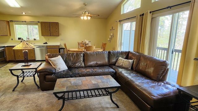 living area with light colored carpet, vaulted ceiling, and a ceiling fan