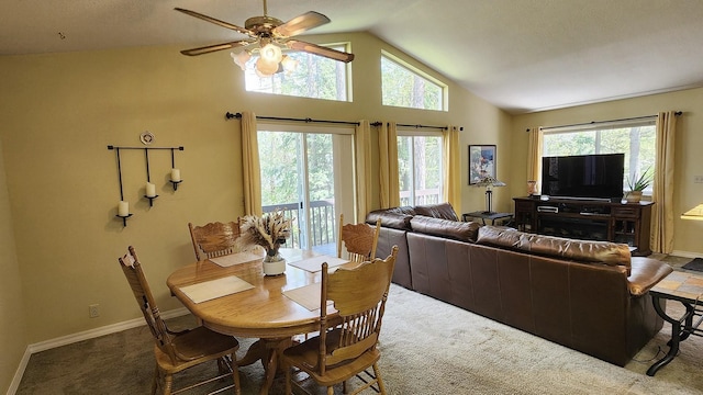 dining room featuring a ceiling fan, baseboards, carpet, and vaulted ceiling