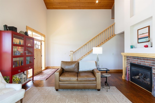 living room featuring wood-type flooring, high vaulted ceiling, baseboards, wooden ceiling, and stairs