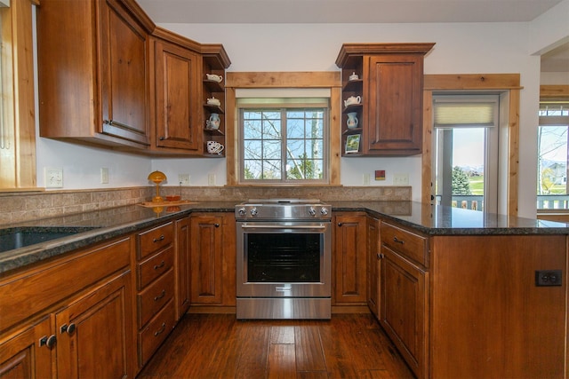 kitchen featuring a peninsula, brown cabinetry, open shelves, and electric stove