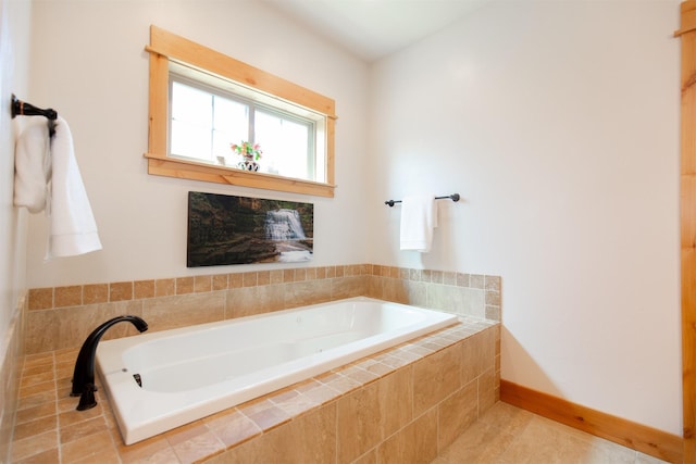 full bath with a garden tub, baseboards, and tile patterned flooring