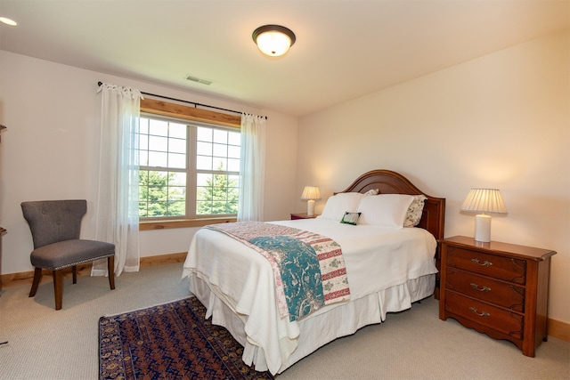 bedroom featuring light carpet, baseboards, and visible vents