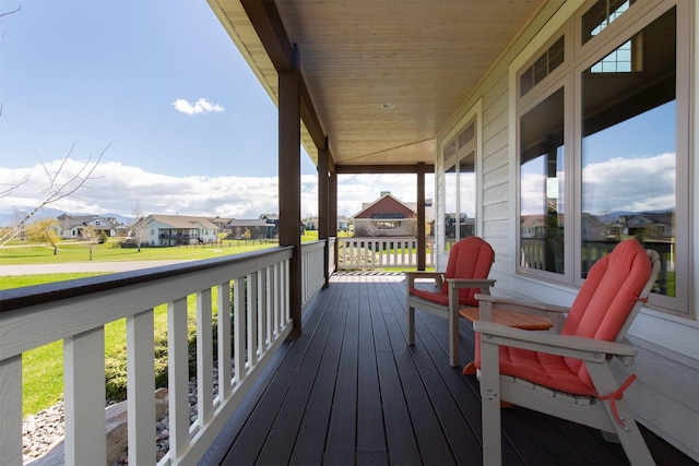 wooden terrace with a residential view