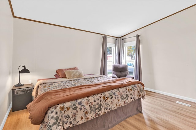 bedroom featuring baseboards, visible vents, and light wood-style floors