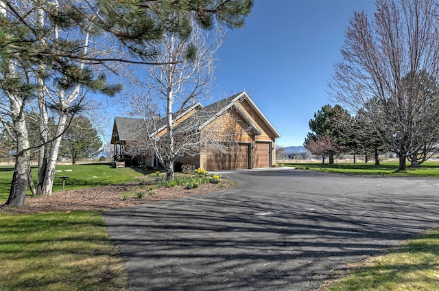 406 Back Nine Ln, Hamilton, MT 59840 - view of side of home with a yard, a garage, and driveway