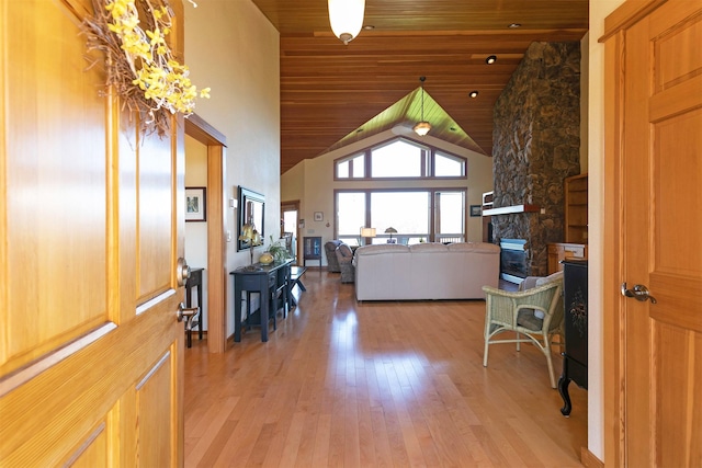 406 Back Nine Ln, Hamilton, MT 59840 - entrance foyer with a fireplace, wood ceiling, high vaulted ceiling, and light wood-style floors