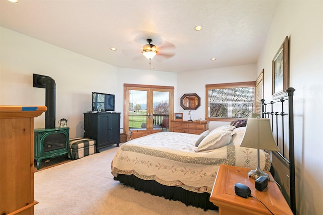 406 Back Nine Ln, Hamilton, MT 59840 - bedroom with a wood stove, carpet flooring, a ceiling fan, and recessed lighting