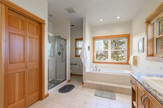 406 Back Nine Ln, Hamilton, MT 59840 - full bathroom with toilet, a healthy amount of sunlight, visible vents, a shower stall, and a bath