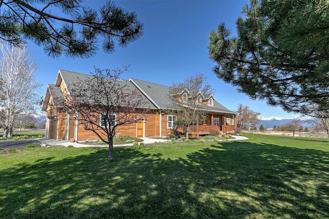406 Back Nine Ln, Hamilton, MT 59840 - rear view of property featuring a yard, a garage, and a porch